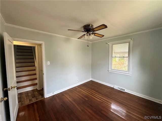 spare room with dark hardwood / wood-style floors, ceiling fan, and ornamental molding