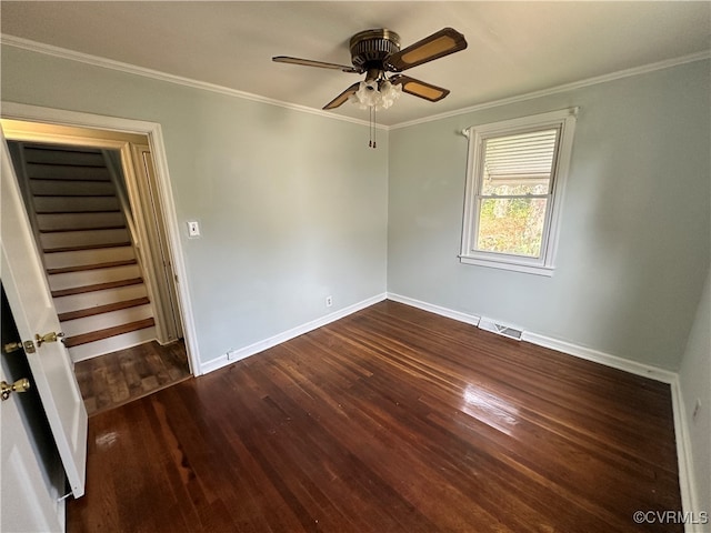 spare room featuring crown molding, ceiling fan, and dark wood-type flooring