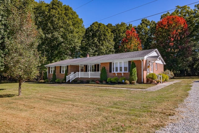 ranch-style house featuring covered porch and a front lawn