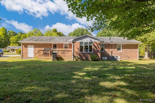 rear view of property featuring a yard and a deck