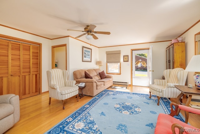 living room featuring ceiling fan, light wood-type flooring, baseboard heating, and ornamental molding