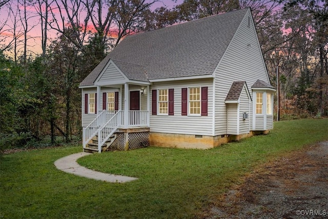 cape cod home with a lawn