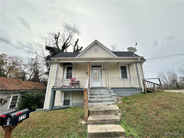 bungalow featuring a front lawn and covered porch