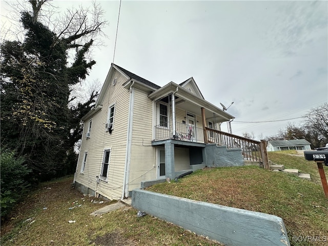 view of property exterior with a lawn and covered porch