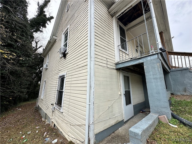 view of side of home with a balcony