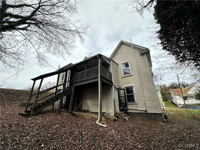 back of property with a balcony