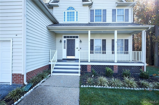 view of front of property with a garage and covered porch