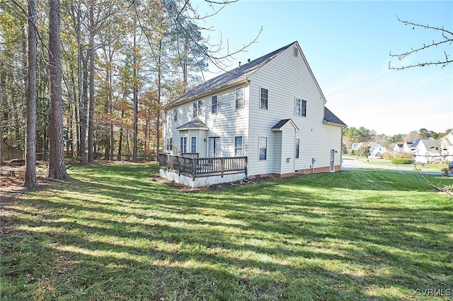 back of property with a yard and a deck