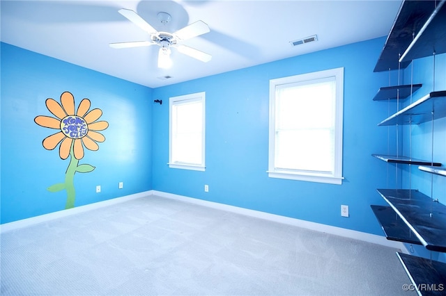 empty room featuring carpet flooring and ceiling fan