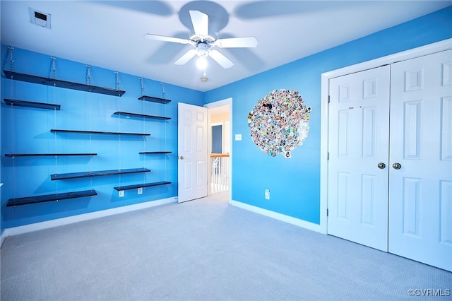 unfurnished bedroom featuring carpet flooring and ceiling fan