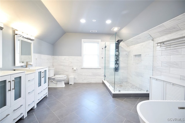 full bathroom featuring shower with separate bathtub, tile patterned flooring, tile walls, and toilet