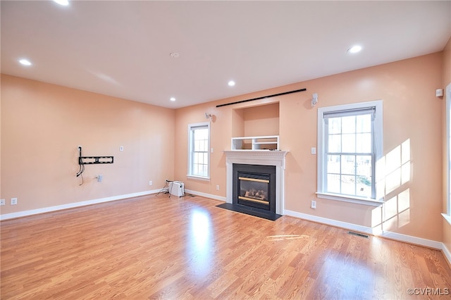 unfurnished living room with plenty of natural light and light wood-type flooring