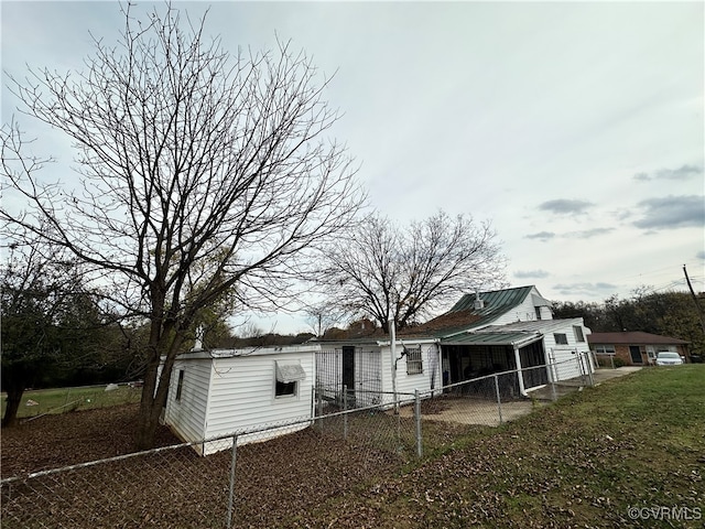 rear view of house featuring a yard