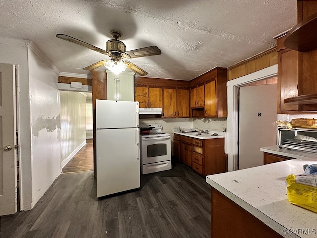 kitchen featuring a textured ceiling, white appliances, ornamental molding, and dark wood-type flooring