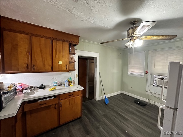 kitchen featuring white refrigerator, ceiling fan, ornamental molding, a textured ceiling, and dark hardwood / wood-style flooring