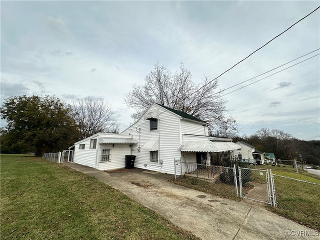 view of side of home with a yard