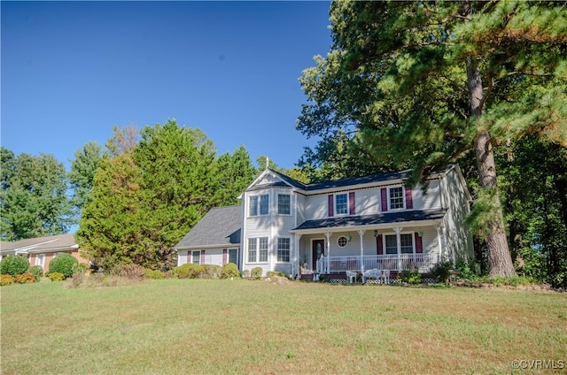 view of front facade with a front lawn and covered porch