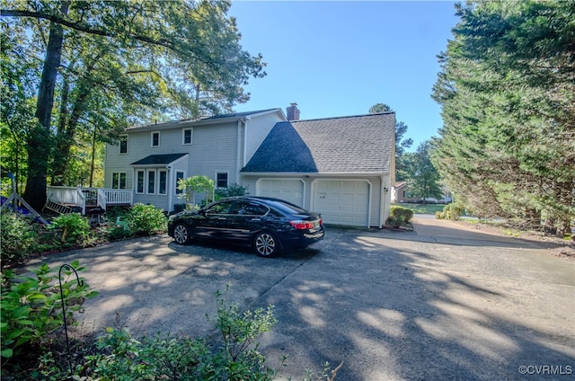 view of front of property with a garage and a wooden deck