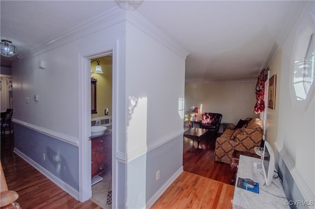 hall with hardwood / wood-style floors and ornamental molding