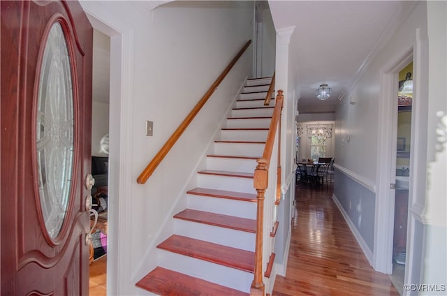 entrance foyer featuring light hardwood / wood-style flooring and ornamental molding