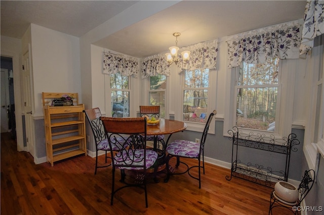 dining space with a chandelier and hardwood / wood-style flooring