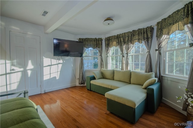 interior space featuring beam ceiling and plenty of natural light