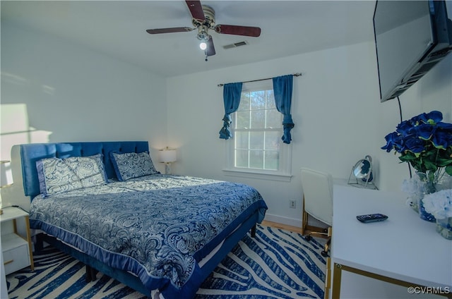 bedroom with ceiling fan and hardwood / wood-style floors