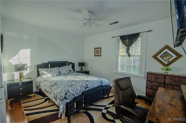 bedroom with ceiling fan and hardwood / wood-style floors