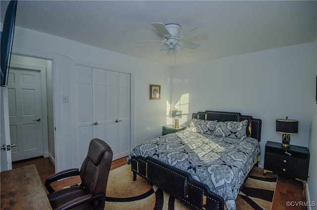 bedroom featuring ceiling fan, a closet, and dark wood-type flooring