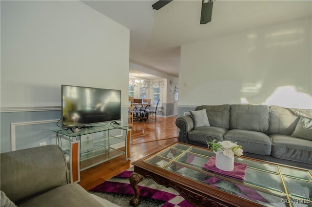 living room with hardwood / wood-style floors, vaulted ceiling, and ceiling fan