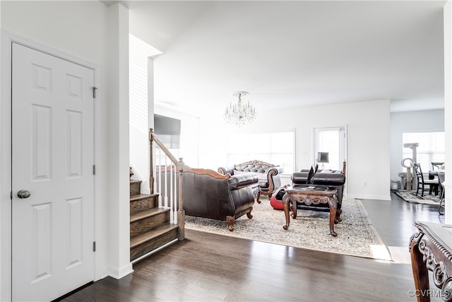 living room featuring dark wood-type flooring and a notable chandelier