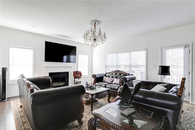 living room with light hardwood / wood-style flooring and a notable chandelier