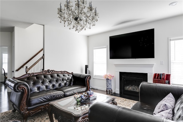 living room featuring a chandelier, a healthy amount of sunlight, and hardwood / wood-style flooring