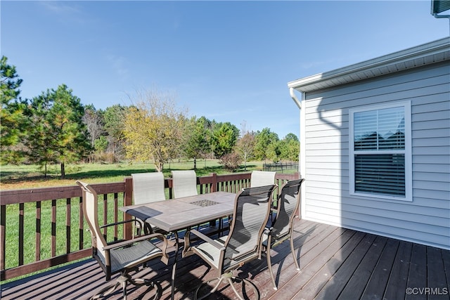 wooden deck featuring a lawn