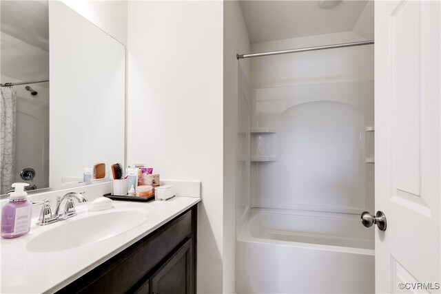 bathroom with vanity, lofted ceiling, and shower / tub combo with curtain