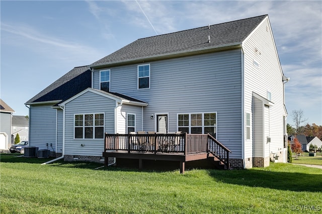 rear view of house featuring a lawn, a wooden deck, and cooling unit