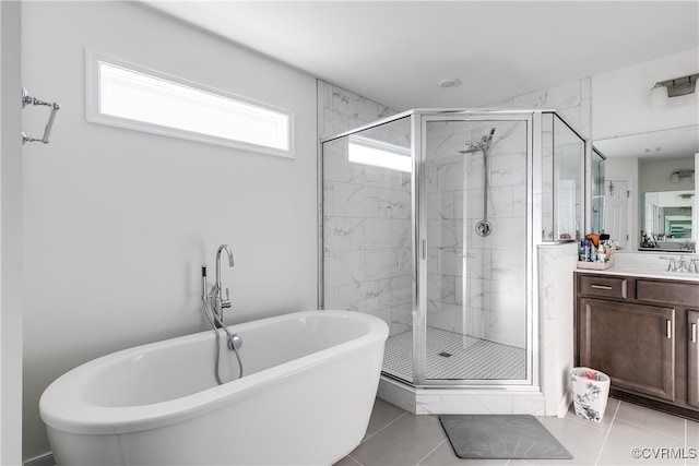 bathroom with tile patterned floors, vanity, and shower with separate bathtub