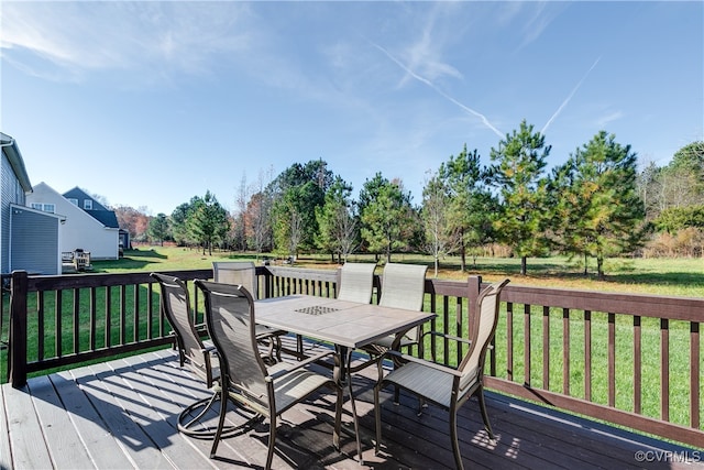 wooden terrace featuring a yard