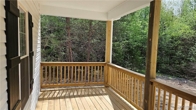 wooden deck with a forest view