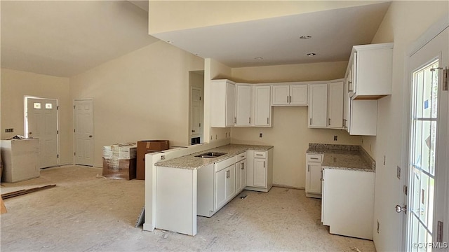 kitchen with light stone countertops and white cabinets