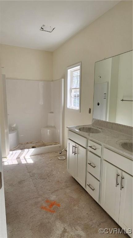 bathroom featuring double vanity and a sink