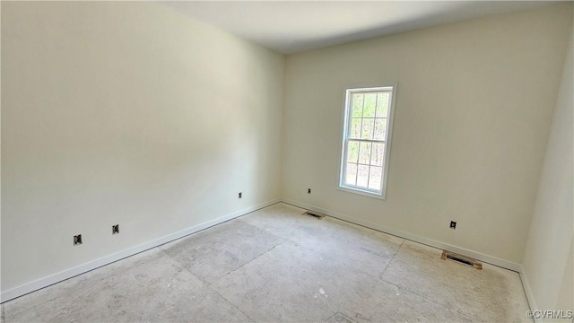 unfurnished room featuring baseboards, visible vents, and concrete flooring