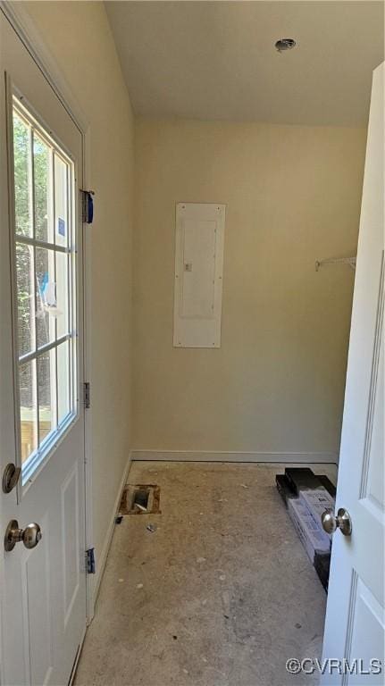 washroom featuring baseboards and electric panel