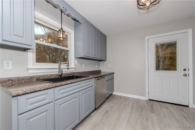 kitchen featuring light wood-type flooring, sink, pendant lighting, dishwasher, and gray cabinets