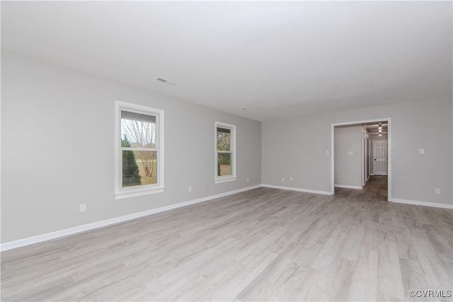 unfurnished room with light wood-type flooring