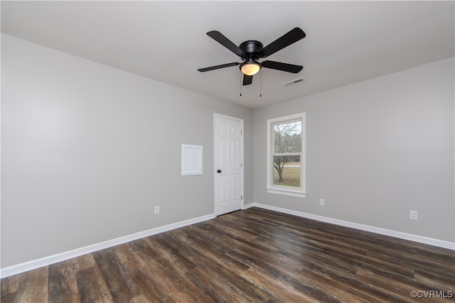 spare room with ceiling fan and dark wood-type flooring