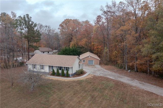 view of front of home with a garage, covered porch, and an outbuilding