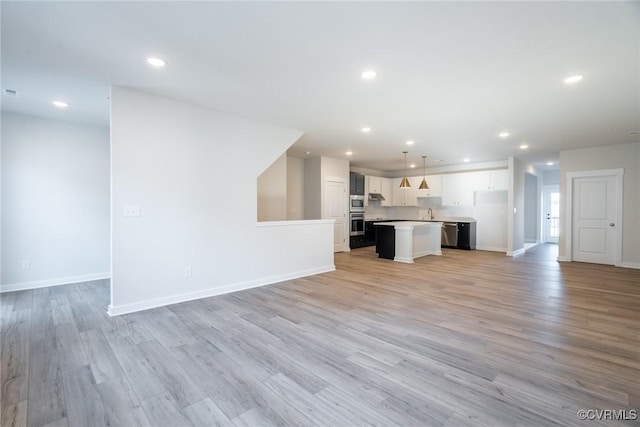 unfurnished living room featuring light hardwood / wood-style floors