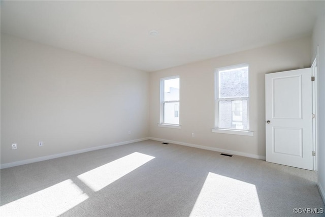 empty room with light colored carpet