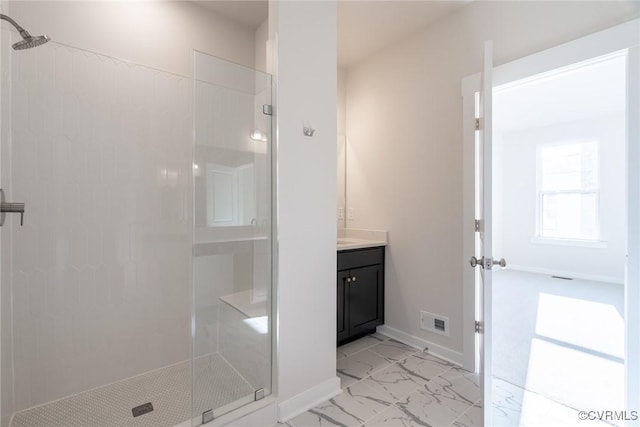 bathroom featuring vanity and a shower with door